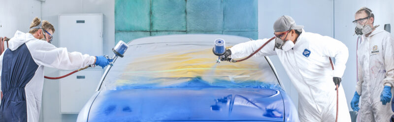 ACC students paint a car at the ACC Auto Body Shop
