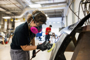 A student sanding car parts during class at Crockett high school (ACC South Austin campus.)