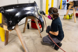 A student sanding car parts during class at Crockett high school (ACC South Austin campus.)