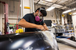 A student sanding car parts during class at Crockett high school (ACC South Austin campus.)