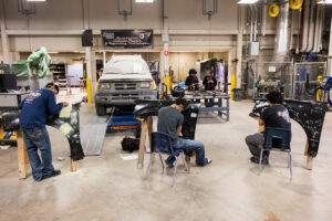 Students working on car parts during class at Crockett high school (ACC South Austin campus.)