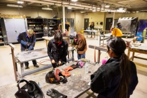 Students working on car parts during class at Crockett high school (ACC South Austin campus.)