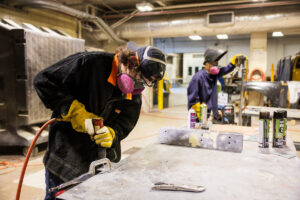 Students working on car parts during class at Crockett high school (ACC South Austin campus.)