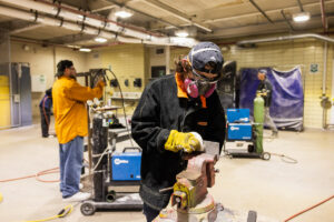 Students working on car parts during class at Crockett high school (ACC South Austin campus.)