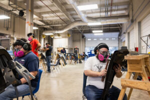 Students working on car parts during class at Crockett high school (ACC South Austin campus.)
