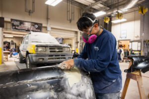 A student sanding car parts during class at Crockett high school (ACC South Austin campus.)