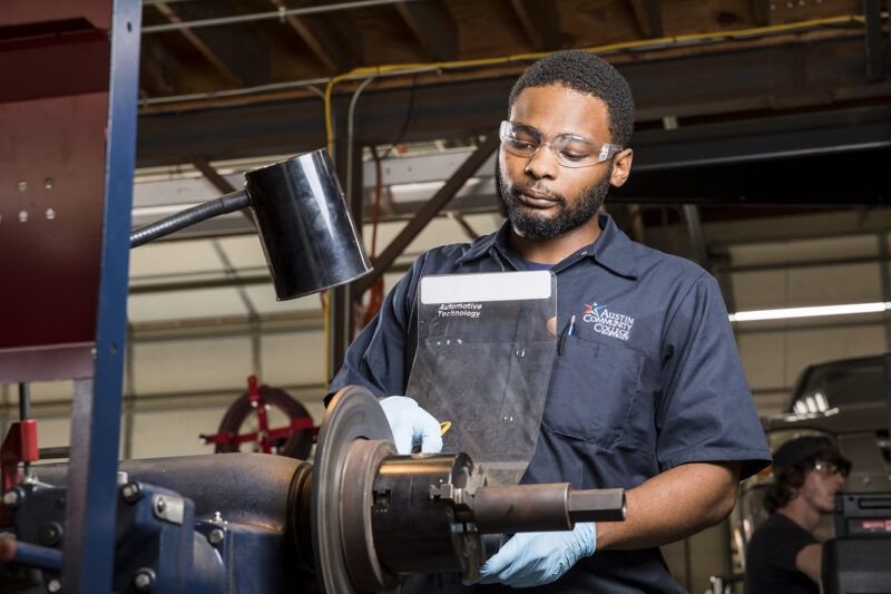 ACC student Kenneth Simmons poses inside the Auto Tech area