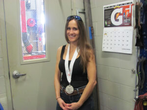 Sarah Stork with 2nd place medal for Welded Steel Sculpture